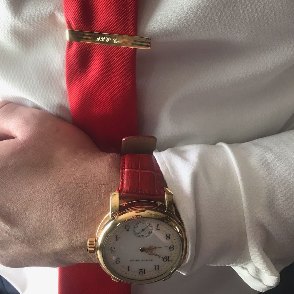 A South Bend Watch Company pocket watch converted to wrist watch on Nicholas Fish's wrist and a matching neck tie holder